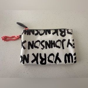 BETSEY JOHNSON wristlet/makeup bag. Black and white. Yellow floral on inside.